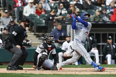 Toronto Blue Jays shortstop Andres Gimenez (0) hits a two-run home run against the Chicago White Sox during the eight inning at Rate Field.