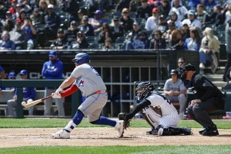 Toronto Blue Jays catcher Alejandro Kirk (30) hits an RBI-double against the Chicago White Sox during the second inning at Rate Field.