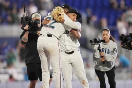 Miami Marlins starting pitcher Sandy Alcantara (22) gets a hug following his complete game shutout win over the Chicago White Sox by third baseman Javier Sanoja (8) at loanDepot Park.