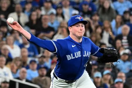 Toronto Blue Jays relief pitcher Louis Varland (77) throws to first base to force out Los Angeles Dodgers first baseman Freddie Freeman (not shown) in the eighth inning at Rogers Centre.
