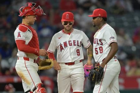 Los Angeles Angels catcher Logan O'Hoppe (14) and shortstop Zach Neto (9) meet at the mound with starting pitcher Jose Soriano (59) during the seventh inning against the Atlanta Braves at Angel Stadium.