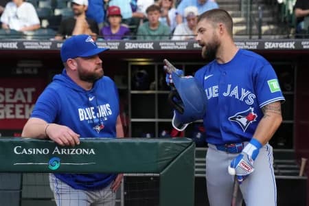 Toronto Blue Jays manager John Schneider (14) talks to right fielder Nathan Lukes (38) against the Arizona Diamondbacks in the first inning at Chase Field.