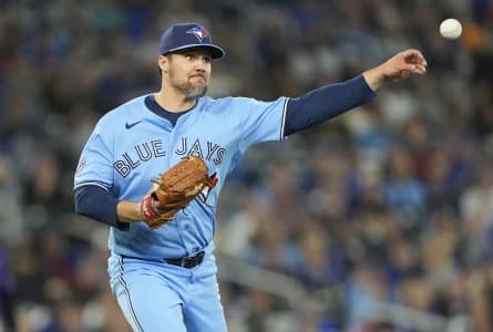 Toronto Blue Jays pitcher Brendon Little (54) throws to first base to get out Colorado Rockies right fielder Troy Johnston (20) during the tenth inning at Rogers Centre.