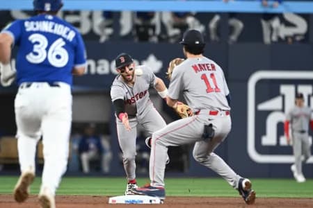 Boston Red Sox shortstop Trevor Story (10) throws the ball to second baseman Marcelo Mayer (11) to start a double play against the Toronto Blue Jays in the third inning at Rogers Centre.