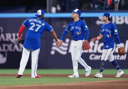 Toronto Blue Jays first baseman Vladimir Guerrero Jr. (27) celebrates the win with shortstop Andres Gimenez (0) against the Cleveland Guardians at the end of the ninth inning at Rogers Centre.