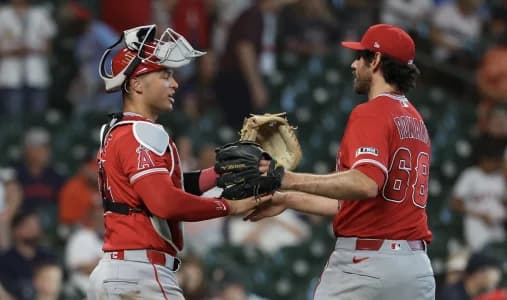 Los Angeles Angels catcher Logan O'Hoppe (14) celebrates the win with pitcher Jordan Romano (68) after defeating the Houston Astros at Daikin Park.