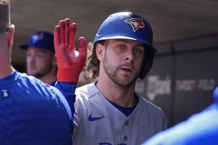 Toronto Blue Jays shortstop Ernie Clement (22) celebrates his run against the Minnesota Twins in the eighth inning on a single by third baseman Kazuma Okamoto (not pictured) at Target Field.
