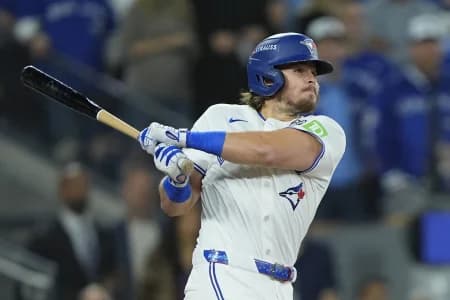 Toronto Blue Jays third baseman Addison Barger (47) hits a single against the Los Angeles Dodgers in the second inning during game seven of the 2025 MLB World Series at Rogers Centre.