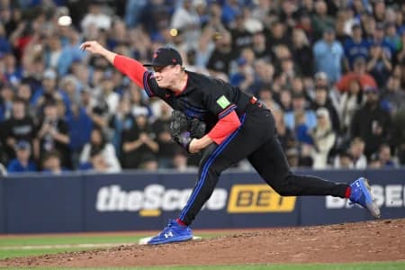 Toronto Blue Jays relief pitcher Louis Varland (77) delivers a pitch against the Los Angeles Angels in the ninth inning at Rogers Centre.