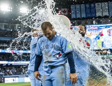 Toronto Blue Jays center fielder Daulton Varsho (5) gets splashed with water after hitting a grand slam walk off to defeat the Tampa Bay Rays during the tenth inning at Rogers Centre.