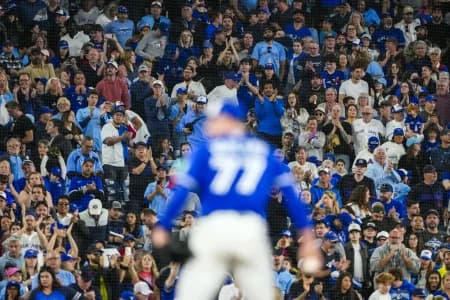 Toronto Blue Jays fans cheer on Toronto Blue Jays pitcher Louis Varland (77) during the ninth inning against the Cleveland Guardians at Rogers Centre.