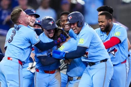 Toronto Blue Jays center fielder Daulton Varsho (5) celebrates hitting a grand slam walk off to defeat the Tampa Bay Rays during the tenth inning with teammates at Rogers Centre.