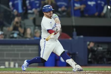 Toronto Blue Jays catcher Alejandro Kirk (30) hits a single against the Los Angeles Dodgers in the seventh inning during game seven of the 2025 MLB World Series at Rogers Centre.