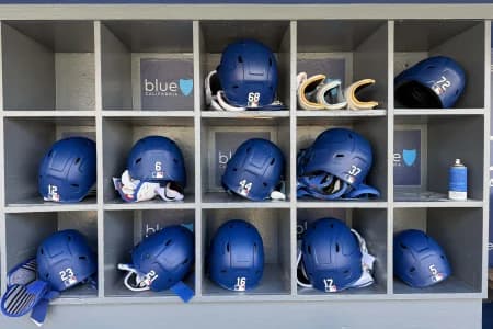 The batting helmets of Los Angeles Dodgers catcher Dalton Rushing (68), shortstop Miguel Rojas (72), left fielder Alex Call (12), shortstop Hyeseong Kim (6), center fielder Andy Pages (44), left fielder Teoscar Hernandez (37), right fielder Kyle Tucker (23), third baseman Santiago Espinal (21), catcher Will Smith (16), left fielder Alex Call (12), first baseman Freddie Freeman (5) in the dugout at Dodger Stadium.
