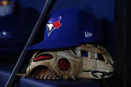 A detail view of a Tampa Bay Rays hat and glove lay in the dugout at Tropicana Field.