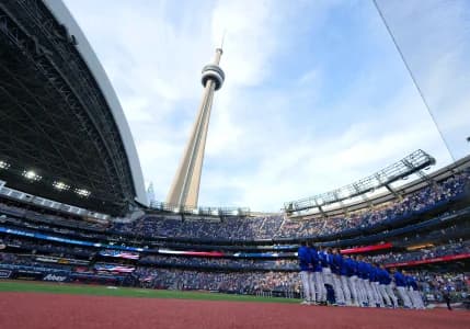 The Toronto Blue Jays stand during the USA national anthem before a game against the Miami Marlins at the Rogers Centre.