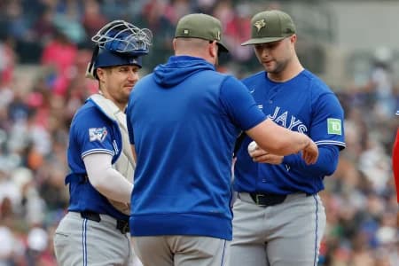Toronto Blue Jays manager John Schneider (14) take the ball to relieve pitcher Mason Fluharty (68) in the second inning against the Detroit Tigers at Comerica Park.
