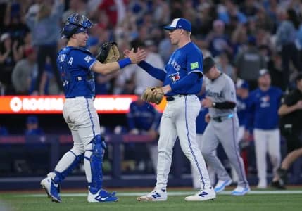 Toronto Blue Jays catcher Brandon Valenzuela (59) celebrates the win with relief pitcher Tanner Andrews (43) against the Miami Marlins at the end of the ninth inning at the Rogers Centre.
