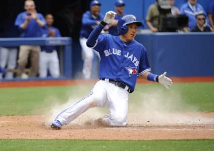 Toronto Blue Jays pinch hitter Munenori Kawasaki (66) scores against Houston Astros from an RBI single by short stop Jose Reyes (7) (not in picture) in the ninth inning at Rogers Centre. Toronto Blue Jays beat Houston Astros 7-6.