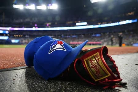 A pair of Toronto Blue Jays hats and glove in the dugout during a game against the Minnesota Twins at Rogers Centre.