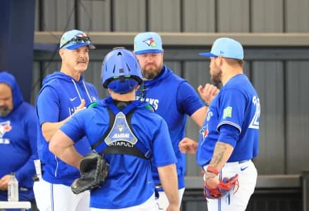 Toronto Blue Jays pitcher Yariel Rodriguez (29) talks with catcher Alejandro Kirk (30), pitching coach Pete Walker (41) and manager John Schneider (14) after he throws a bullpen session for spring training practice at Blue Jays Player Development Complex.
