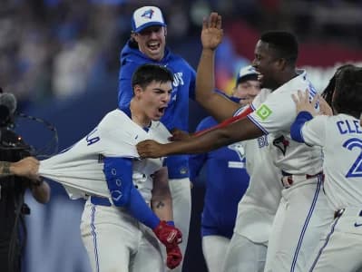Toronto Blue Jays designated hitter Jesus Sanchez (12) and other team mates congratulate catcher Brandon Valenzuela (59) on his game winning walk off RBI single against the Philadelphia Phillies during the ninth inning at Rogers Centre