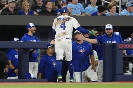 Toronto Blue Jays designated hitter George Springer (4) celebrates scoring against the Philadelphia Phillies during the seventh inning at Rogers Centre.