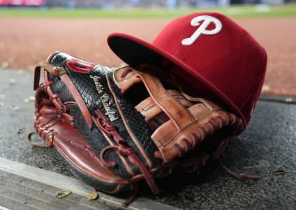 The glove and hat of Philadelphia Phillies center fielder Justin Crawford (2) in the dugout during a game against the Toronto Blue Jays at Rogers Centre.