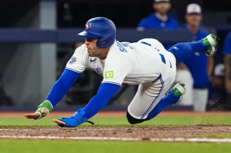 Toronto Blue Jays designated hitter George Springer (4) slides into home plate during the seventh inning against the Philadelphia Phillies at Rogers Centre.