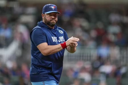 Toronto Blue Jays manager John Schneider (14) on the field against the Atlanta Braves during the eighth inning at Truist Park.