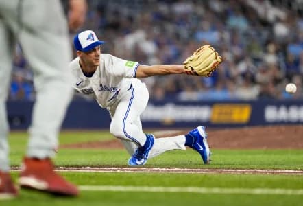 Toronto Blue Jays pitcher Tyler Rogers (71) makes a glove pass to first base against the Philadelphia Phillies during the eighth inning at Rogers Centre.