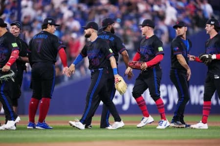 Toronto Blue Jays third baseman Kazuma Okamoto (7) celebrates the win with right fielder Nathan Lukes (38) against the New York Yankees at the end of the ninth inning at Rogers Centre.