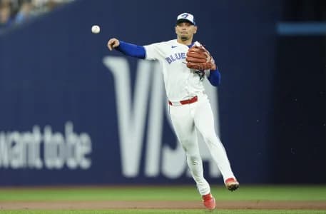 Toronto Blue Jays shortstop Andres Gimenez (0) throws out Philadelphia Phillies shortstop Trea Turner (not pictured) at first base during the third inning at Rogers Centre.