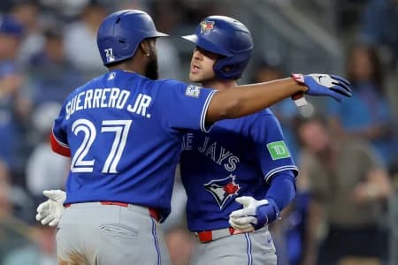 Toronto Blue Jays shortstop Ernie Clement (22) celebrates his three run home run against the New York Yankees with first baseman Vladimir Guerrero Jr. (27) during the fourth inning at Yankee Stadium.