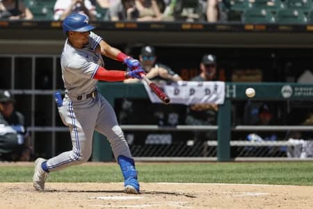 Toronto Blue Jays second baseman Santiago Espinal (5) singles against the Chicago White Sox during the fourth inning at Guaranteed Rate Field.