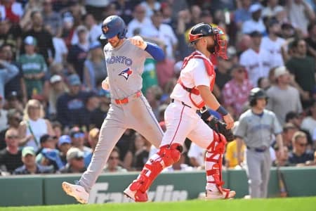 Toronto Blue Jays second baseman Ernie Clement (22) scores a run against the Boston Red Sox during the ninth inning at Fenway Park.
