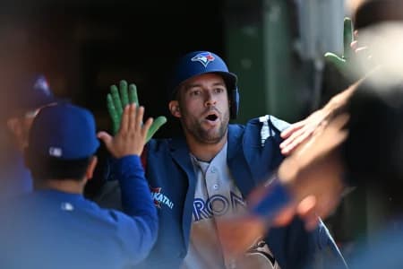 Toronto Blue Jays designated hitter George Springer (4) celebrates his a home run with teammates in the dugout against the Chicago Cubs during the sixth inning at Wrigley Field.