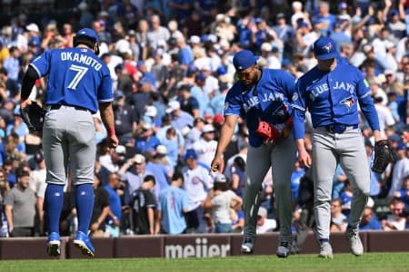 Toronto Blue Jays first baseman Vladimir Guerrero Jr. (27) and third baseman Kazuma Okamoto (7) celebrate after defeating the Chicago Cubs at Wrigley Field.
