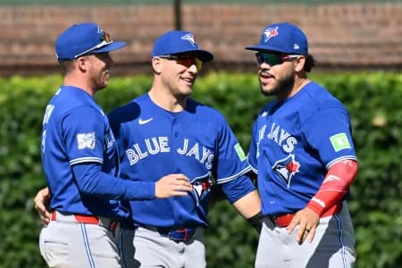 The Toronto Blue Jays celebrate after defeating the Chicago Cubs at Wrigley Field.