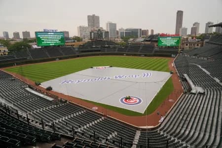 The Tarp is seen on the field as a game between the Chicago Cubs and the Toronto Blue Jays has been postponed due to weather at Wrigley Field.