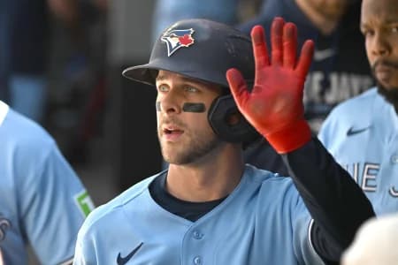 Toronto Blue Jays second baseman Ernie Clement (22) celebrates in the dugout with team mates after scoring a run against the Baltimore Orioles in the second inning at Rogers Centre.