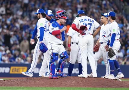 Toronto Blue Jays starting pitcher Dylan Cease (84) is relieved by manager John Schneider (14) against the Houston Astros during the sixth inning at Rogers Centre.