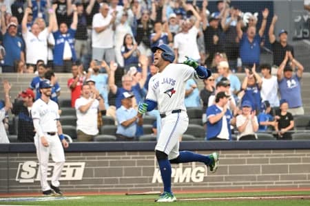 Toronto Blue Jays designated hitter George Springer (4) reacts after scoring a run on a triple and an error against the New York Mets in the first inning at Rogers Centre.