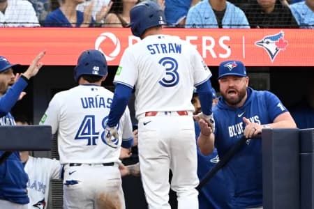Toronto Blue Jays center fielder Myles Straw (3) is greeted by manager John Schneider (14) after his sacrifice fly scored second baseman Luis Urias (48) against the New York Mets in the fifth inning at Rogers Centre.