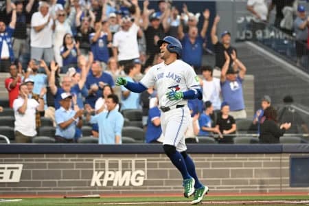 Toronto Blue Jays designated hitter George Springer (4) reacts after scoring a run on a triple and an error against the New York Mets in the first inning at Rogers Centre.