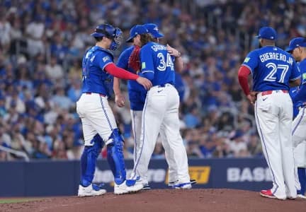 Toronto Blue Jays pitcher Kevin Gausman (34) is relieved by manager John Schneider (14) against the Tampa Bay Rays during the fourth inning at Rogers Centre