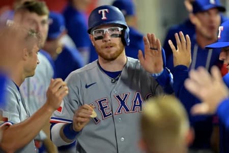 Texas Rangers catcher Danny Jansen (9) in the dugout after a solo home run in the ninth inning against the Los Angeles Angels at Angel Stadium.