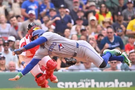 Boston Red Sox catcher Connor Wong (12) tags Toronto Blue Jays designated hitter George Springer (4) out during the eighth inning at Fenway Park.