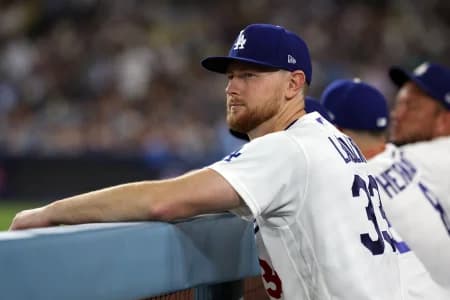 Los Angeles Dodgers pitcher Eric Lauer (33) watches a game from the dugout during the seventh inning against the Seattle Mariners at Dodger Stadium