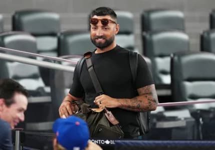 Former Toronto Blue Jays player Kevin Pillar speaks to a member of the New York Mets during batting practice before a game at Rogers Centre.